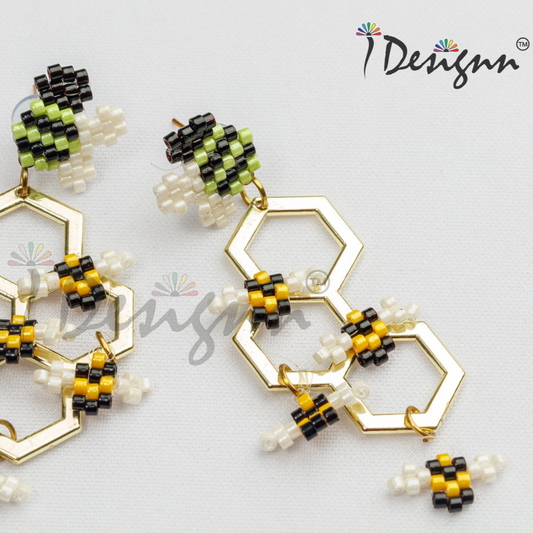 Hexagonal beaded earrings with yellow and black details on a light gray background
