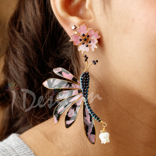 Close-up of a person wearing decorative earrings with a blurred background
