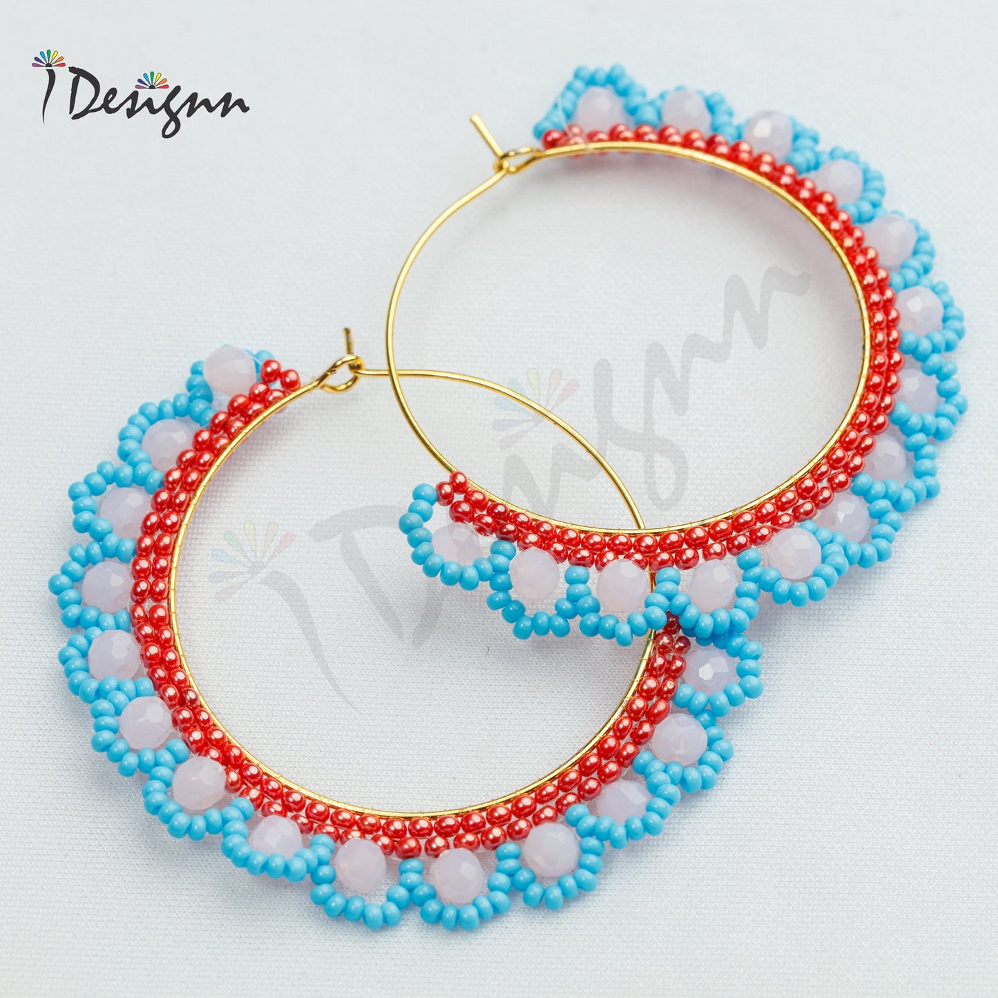 Pair of beaded hoop earrings with red, blue, and white beads on a light gray background.